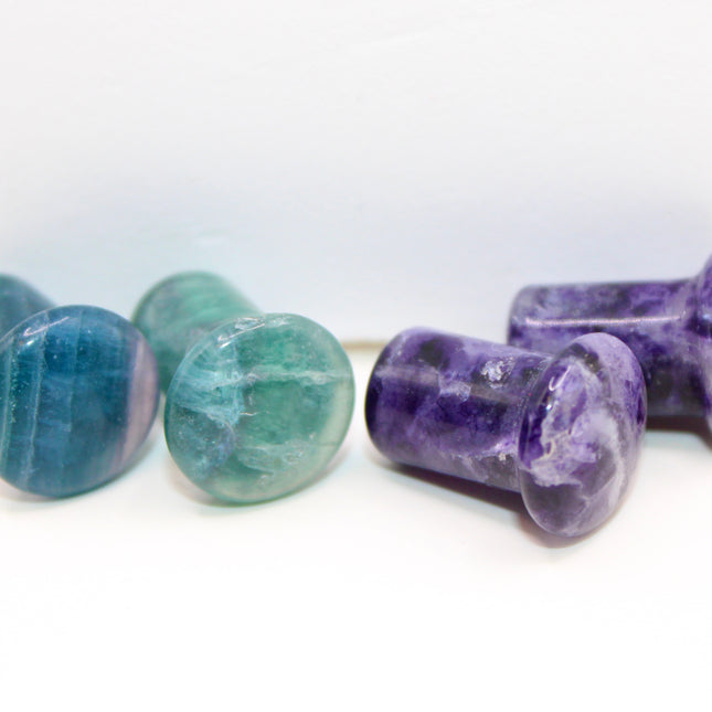 Fluorite single flare plugs is a highly protective and mentally uplifting stone, known for enhancing clarity, focus, and spiritual alignment. Often connected to the third eye and crown chakras, it helps cleanse negative energy and bring calm, balanced thinking. The stunning bands of purple, green, and clear make it as visually striking as it is energetically supportive.