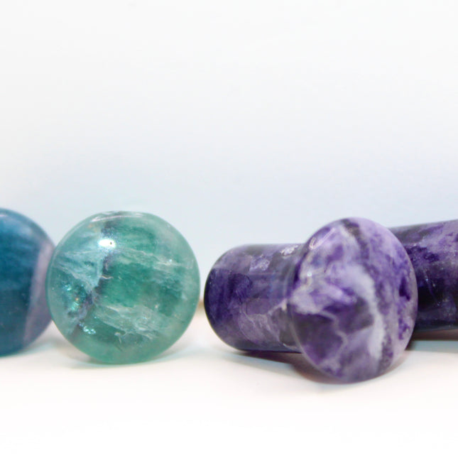 Fluorite single flare plugs is a highly protective and mentally uplifting stone, known for enhancing clarity, focus, and spiritual alignment. Often connected to the third eye and crown chakras, it helps cleanse negative energy and bring calm, balanced thinking. The stunning bands of purple, green, and clear make it as visually striking as it is energetically supportive.