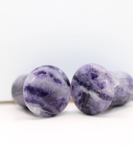 Fluorite single flare plugs is a highly protective and mentally uplifting stone, known for enhancing clarity, focus, and spiritual alignment. Often connected to the third eye and crown chakras, it helps cleanse negative energy and bring calm, balanced thinking. The stunning bands of purple, green, and clear make it as visually striking as it is energetically supportive.