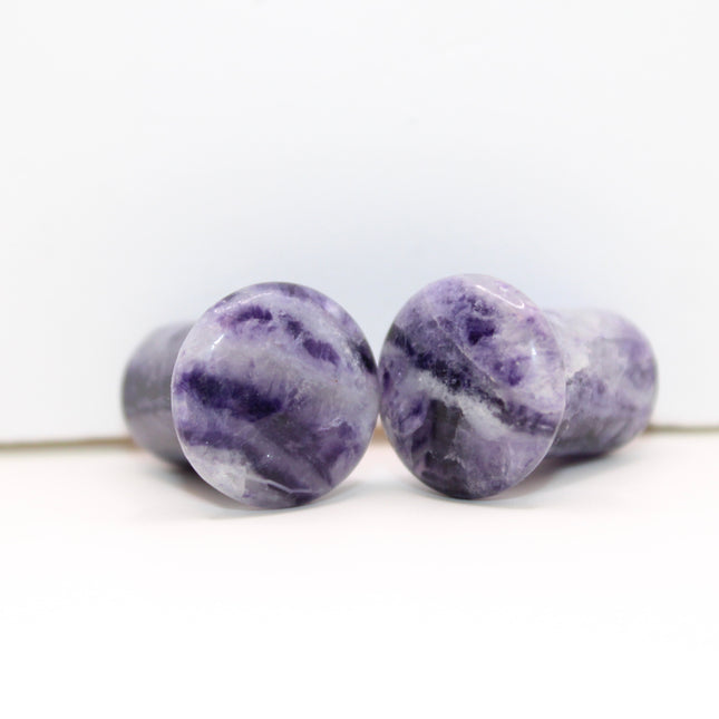 Fluorite single flare plugs is a highly protective and mentally uplifting stone, known for enhancing clarity, focus, and spiritual alignment. Often connected to the third eye and crown chakras, it helps cleanse negative energy and bring calm, balanced thinking. The stunning bands of purple, green, and clear make it as visually striking as it is energetically supportive.