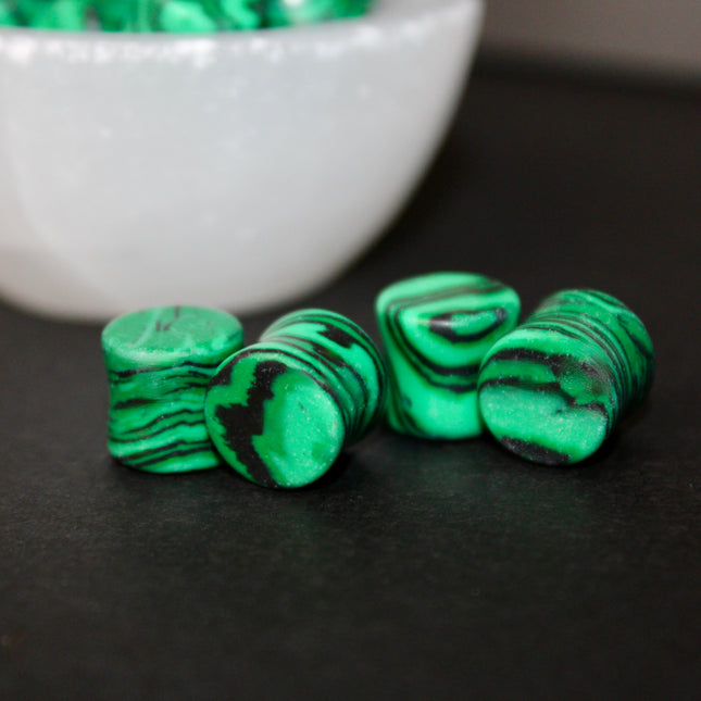 These Green and Black Synthetic Malachite Double Flare Plugs are perfect for anyone seeking a bold, polished look with nature-inspired vibes—great for everyday wear or completing your crystal-themed plug collection.