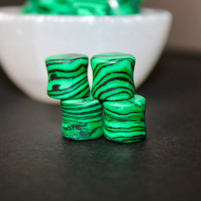 These Green and Black Synthetic Malachite Double Flare Plugs are perfect for anyone seeking a bold, polished look with nature-inspired vibes—great for everyday wear or completing your crystal-themed plug collection.