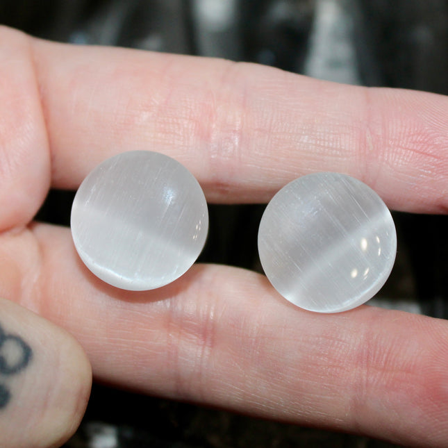 Silver Cat’s Eye glass is known for its sophisticated shimmer and luminous, moving line—known as chatoyancy—that dances across the surface like a beam of light. The cool, metallic tone represents clarity, balance, and subtle strength, making it a versatile choice for everyday wear or a sleek accent piece.