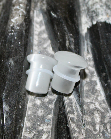 Silver Cat’s Eye glass is known for its sophisticated shimmer and luminous, moving line—known as chatoyancy—that dances across the surface like a beam of light. The cool, metallic tone represents clarity, balance, and subtle strength, making it a versatile choice for everyday wear or a sleek accent piece.