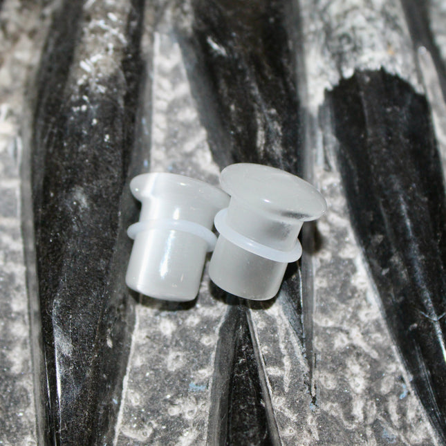 Silver Cat’s Eye glass is known for its sophisticated shimmer and luminous, moving line—known as chatoyancy—that dances across the surface like a beam of light. The cool, metallic tone represents clarity, balance, and subtle strength, making it a versatile choice for everyday wear or a sleek accent piece.