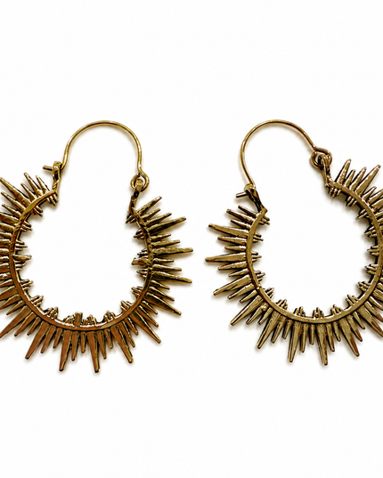 A pair of gold-toned metal hoop earrings with radiating sunburst spikes, displayed on a clean white background.