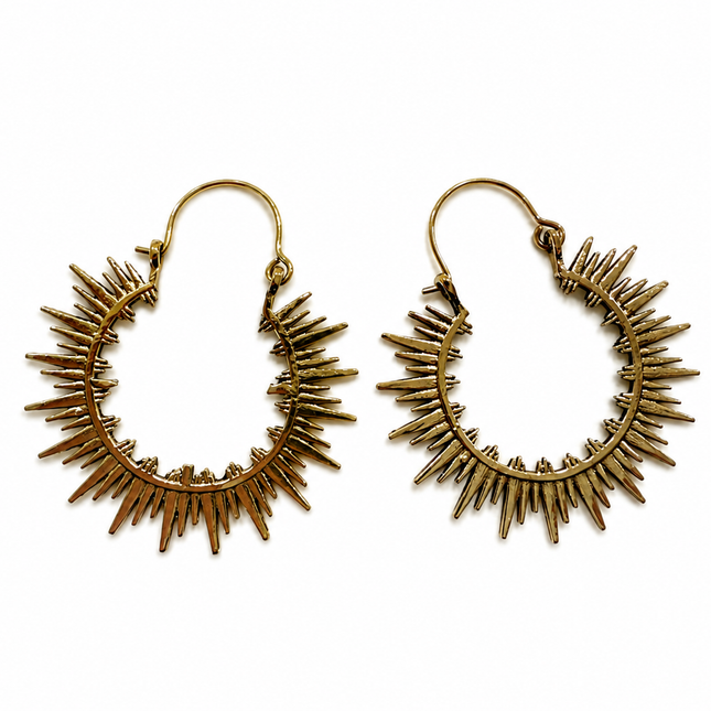 A pair of gold-toned metal hoop earrings with radiating sunburst spikes, displayed on a clean white background.