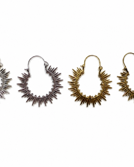 Four sunburst hoop earrings in silver, rose gold, and gold finishes, arranged in a row against a plain white background.