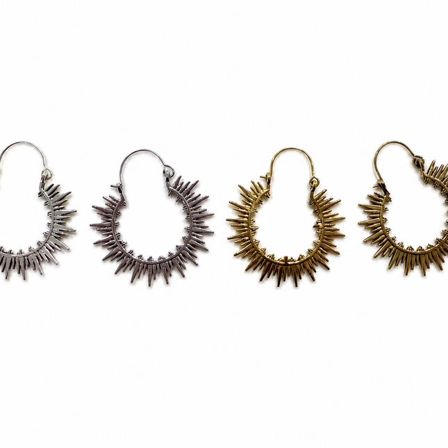 Four sunburst hoop earrings in silver, rose gold, and gold finishes, arranged in a row against a plain white background.