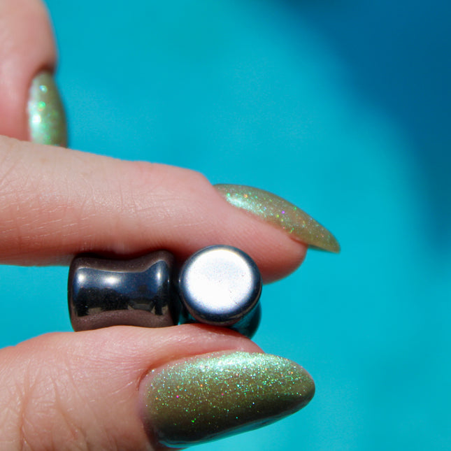 Crafted from polished natural hematite, these plugs offer a sleek, metallic finish with a cool, gunmetal-gray sheen. Smooth and weighty, hematite plugs provide a comfortable fit while giving off a bold, minimalist look. Known for its grounding and balancing properties, hematite is a favorite among those who seek both style and energetic stability. Ideal for stretched ears, these plugs combine natural beauty with a modern edge.