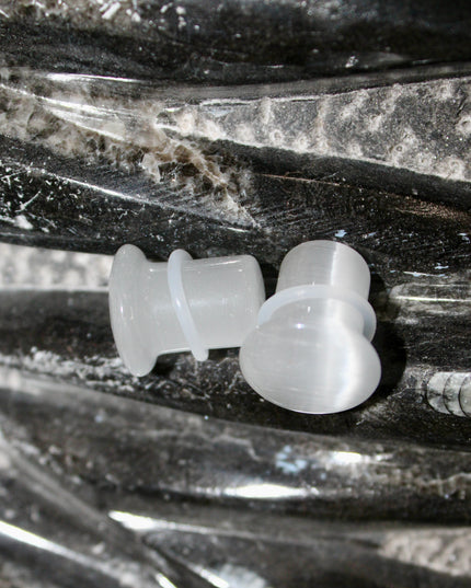 Silver Cat’s Eye glass is known for its sophisticated shimmer and luminous, moving line—known as chatoyancy—that dances across the surface like a beam of light. The cool, metallic tone represents clarity, balance, and subtle strength, making it a versatile choice for everyday wear or a sleek accent piece.